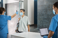 health care personnel performing temperature screening