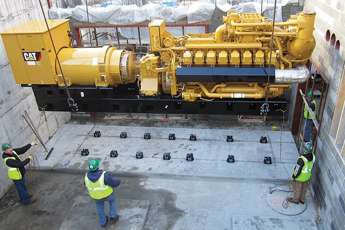 generator set being lifted into a mechanical pit