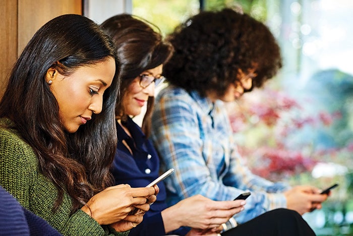 millennials in waiting room on smartphones