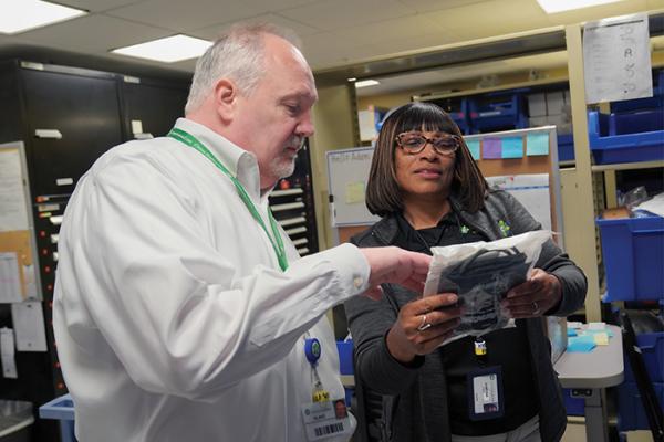 Vanessa Pope (right), a biomedical clerk at ChristianaCare, discusses equipment with Director of Clinical Engineering Blake Collins.