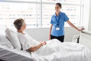 Environmental services staff speaking with patient